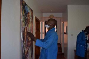 Professional movers from Access Movers Kenya mounting a picture on the wall