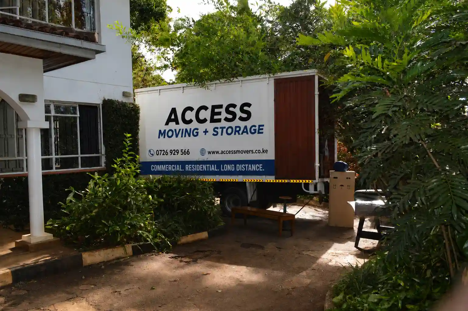 Professional movers in Nairobi. A trained moving team loads household furniture. They use a branded Access Movers Kenya truck in Nairobi